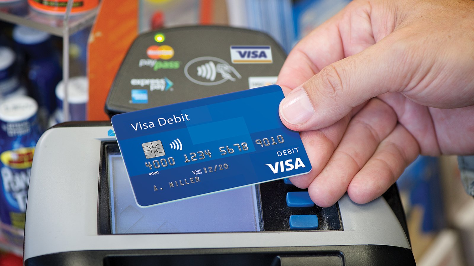 Photo of a hand using a contactless card to pay representing the Visa PIN Security data security compliance needs