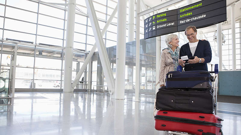 Travelling couple waiting checking to ensure they have VISA credit card for their travels