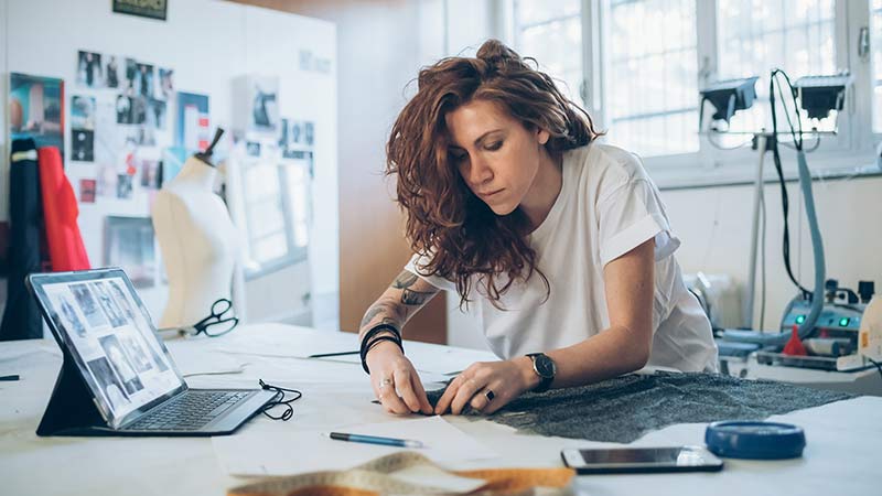 A woman fashion designer at work preparing a new piece.