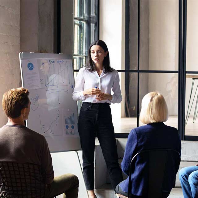 Woman leading meeting in an office.