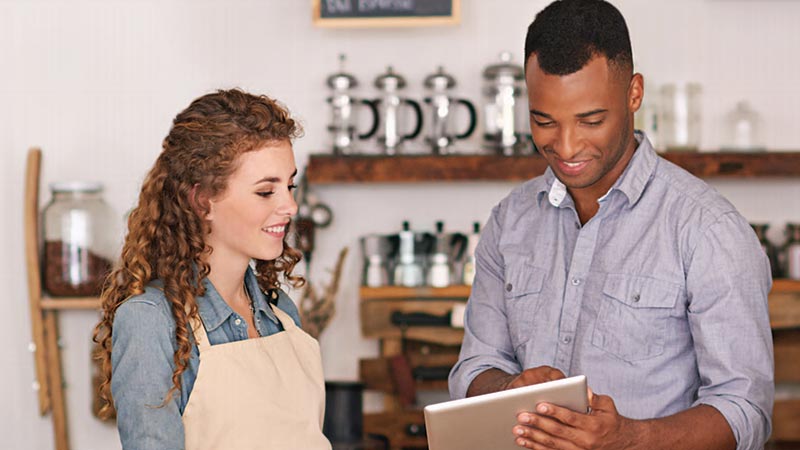 Merchants using a tablet for businesses