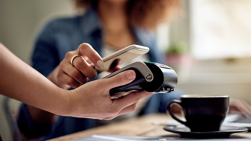 Women using a mobile phone for payment