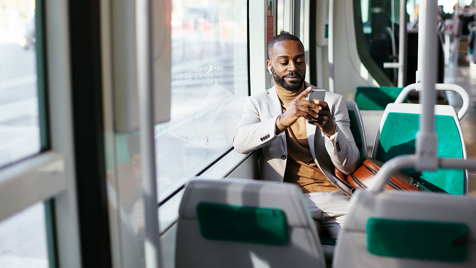 man on bus using mobile